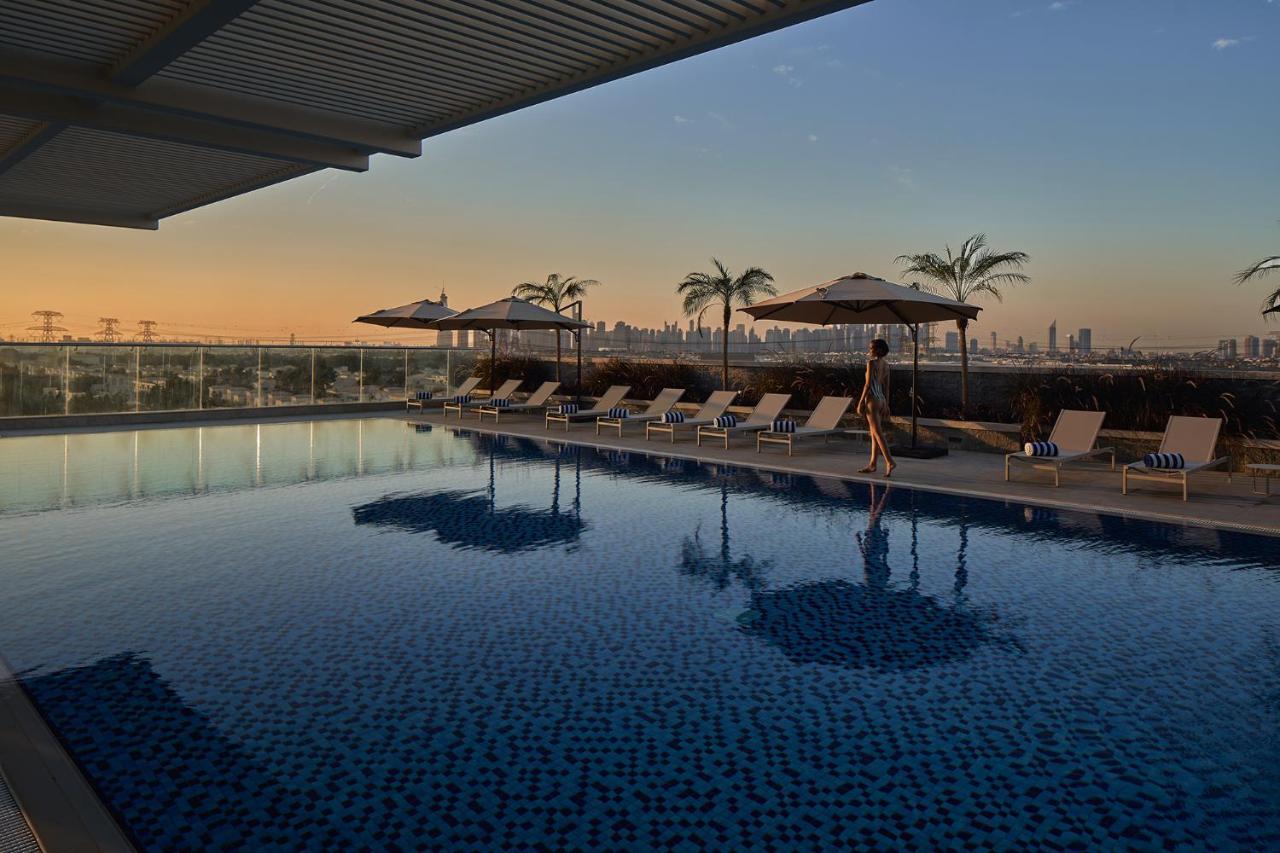 Movenpick Jumeirah Village Triangle Dubai Bagian luar foto The rooftop pool at the hotel
