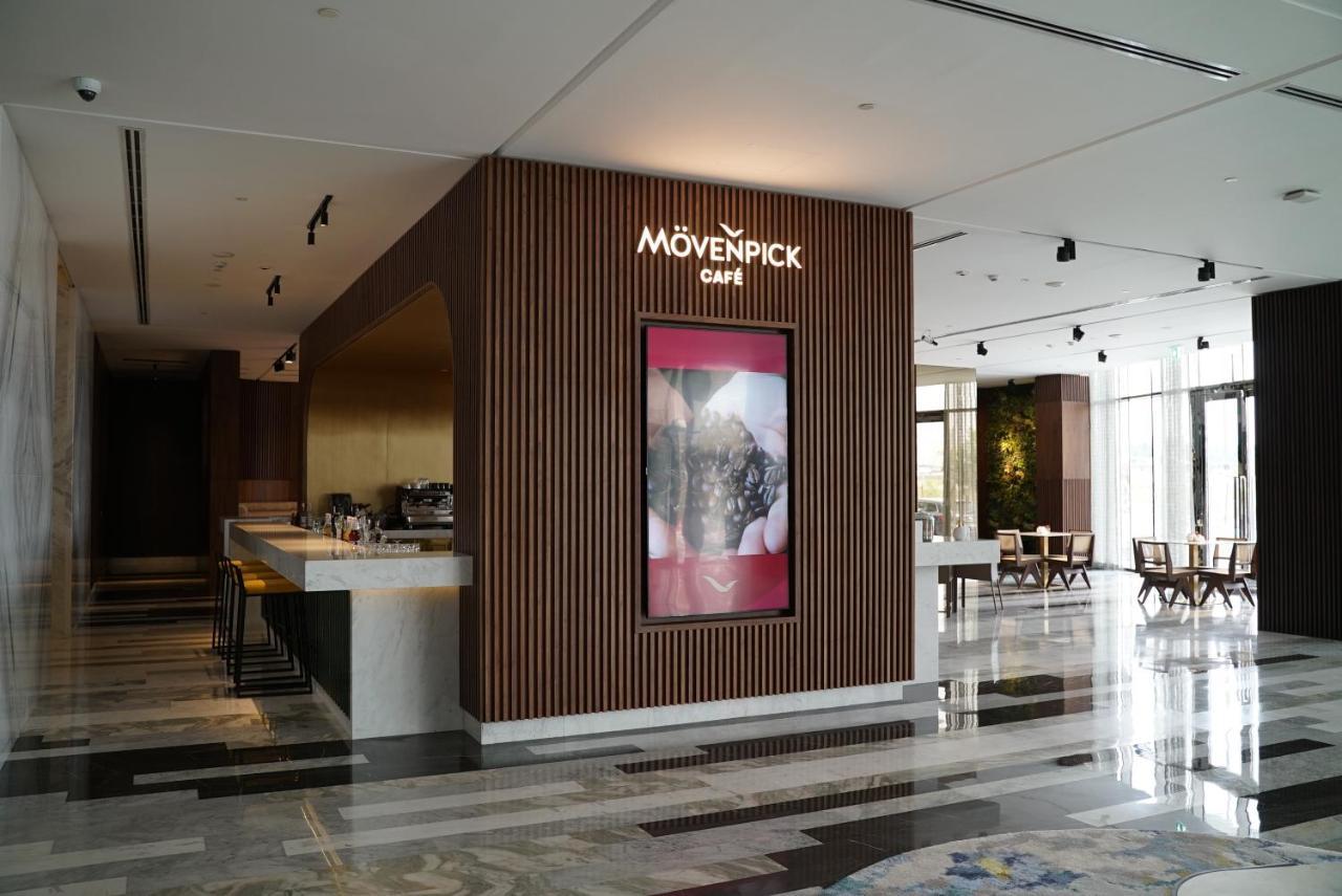 Movenpick Jumeirah Village Triangle Dubai Bagian luar foto Mövenpick Café in the lobby of the Kempinski Hotel, Amman, Jordan